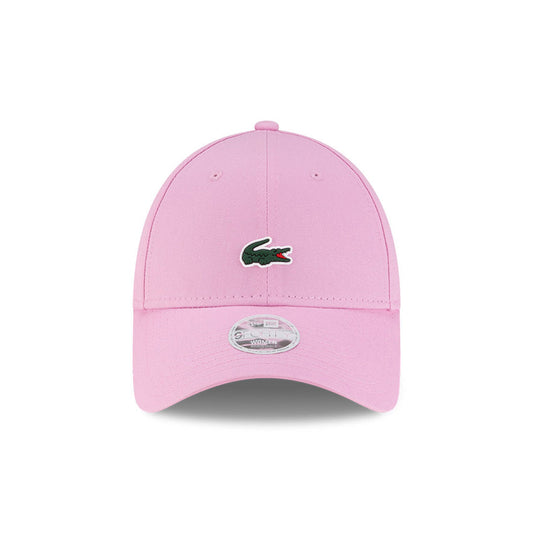 Front view of New Era x Lacoste 9FORTY Women Core Pastel Pink Adjustable Cap highlighting the centered crocodile logo