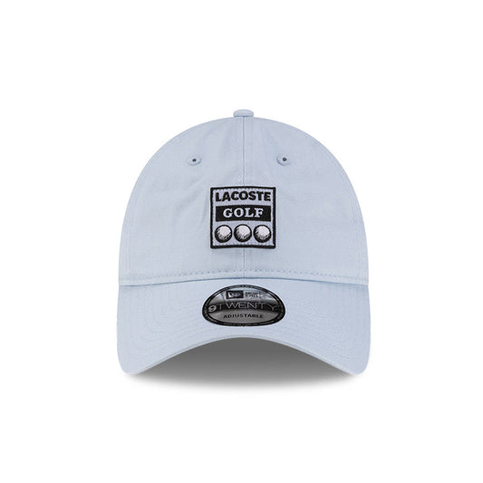 Front view of New Era x Lacoste 9TWENTY Golf Ball Pastel Blue Adjustable Cap highlighting the rectangular Lacoste Golf patch