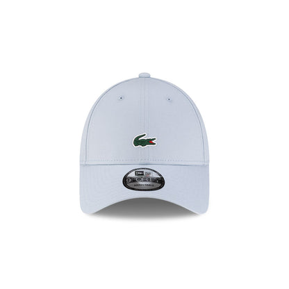 Front view of New Era x Lacoste 9FORTY Core Light Blue Adjustable Cap highlighting the centered crocodile logo