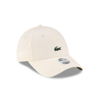 Front right view of New Era x Lacoste 9FORTY Women Core Light Beige Adjustable Cap displaying the classic crown.