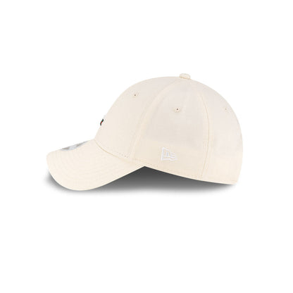Left side profile view of New Era x Lacoste 9FORTY Women Core Light Beige Adjustable Cap featuring stitched white flag logo.