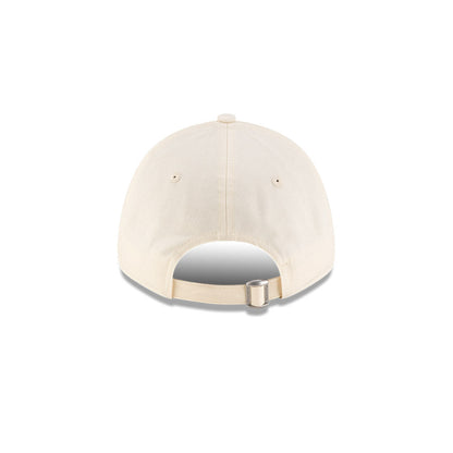 Rear view of New Era x Lacoste 9FORTY Women Core Light Beige Adjustable Cap showcasing cloth strapback and metal closure.