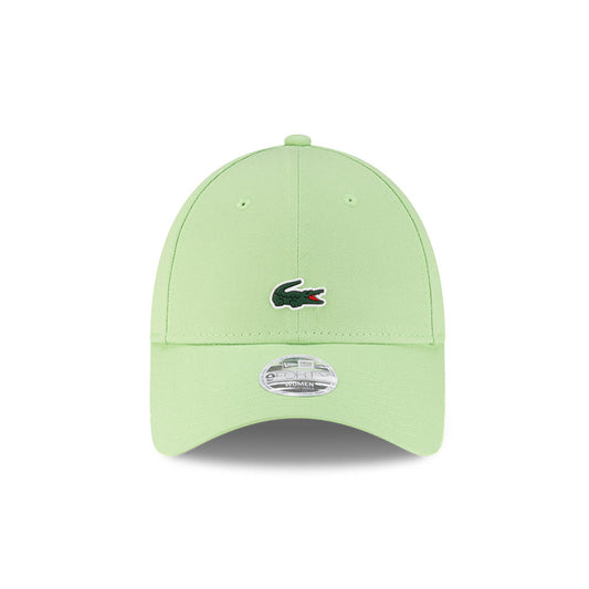 Front view of New Era x Lacoste 9FORTY Women Core Pastel Green Adjustable Cap highlighting the centered crocodile logo