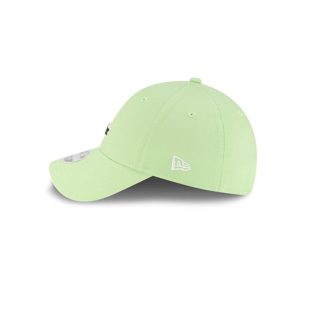 Left side profile view of New Era x Lacoste 9FORTY Women Core Pastel Green Adjustable Cap featuring stitched white flag logo.