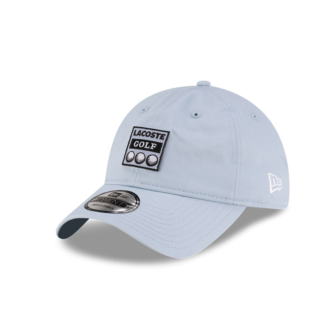 Front left view of New Era x Lacoste 9TWENTY Golf Ball Pastel Blue Adjustable Cap displaying the relaxed unstructured crown.