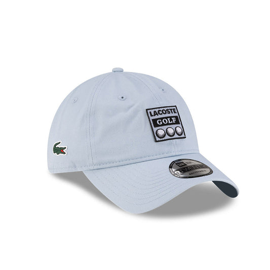 Front right view of New Era x Lacoste 9TWENTY Golf Ball Pastel Blue Adjustable Cap highlighting the side crocodile logo