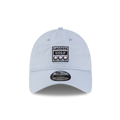 Front view of New Era x Lacoste 9TWENTY Golf Ball Pastel Blue Adjustable Cap highlighting the rectangular Lacoste Golf patch